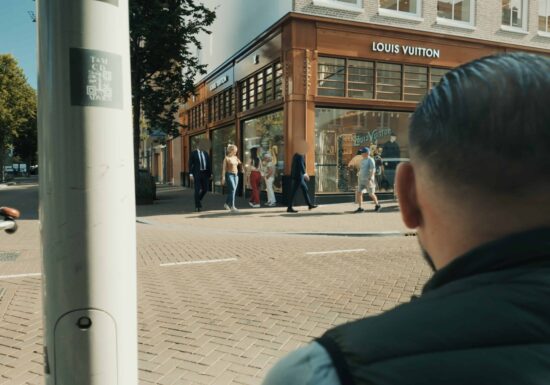 Covert Executive Protection | Infinite Risks International | Street view of a Louis Vuitton store with pedestrians walking by.