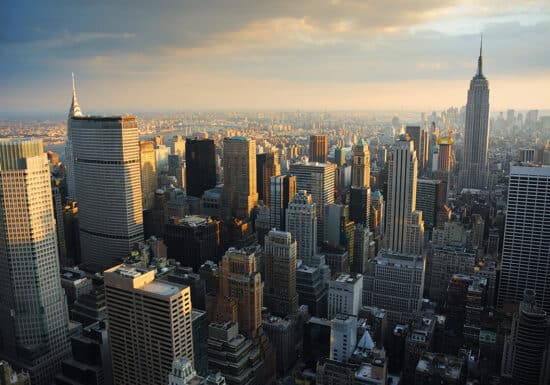 Bodyguard Services in New York. The New York City skyline at sunset, featuring the Empire State Building and Chrysler Building.