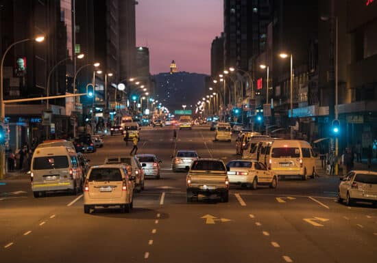 VIP Protection in South Africa. Busy city street at night with traffic and buildings, possibly in an African city.