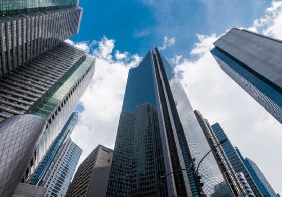 Bodyguard services in the Philippines. A low-angle view of modern skyscrapers against a partly cloudy sky in the Philippines.