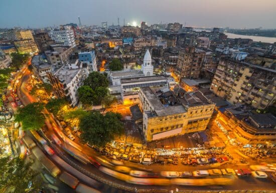 Bodyguard Services in India. Busy evening street scene in a densely populated urban area, likely in India.