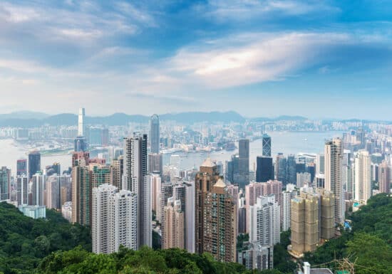 Bodyguard Services in Hong Kong./ Hong Kong skyline with tall skyscrapers and Victoria Harbour.