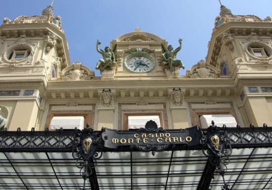 Bodyguard services in Monaco. Facade of the iconic Casino Monte-Carlo in Monaco, featuring ornate architecture and a clock above the entrance.