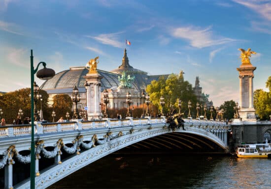 French speaking bodyguard. Pont Alexandre III bridge in Paris with the Grand Palais in the background.