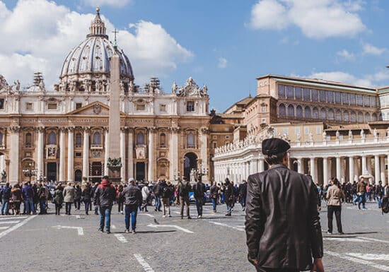 Covert Executive Protection. A crowd of people, including police officers, gathered in front of St. Peter's Basilica at the Vatican.