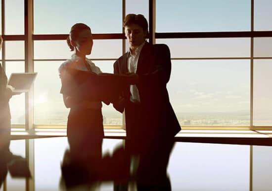 Security Audits. Business people working and discussing documents in a spacious office with large windows.